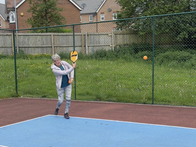 Action shot of a lady hitting the ball.