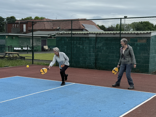 Getting down to hit the ball.