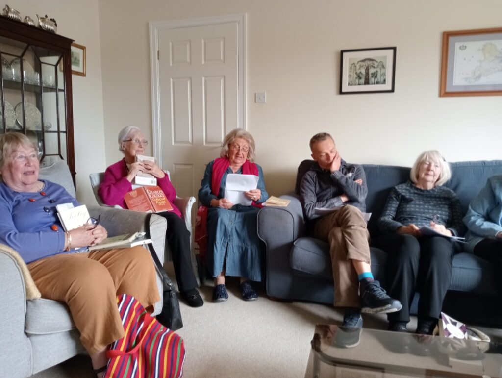 Members listening to a poem being read.