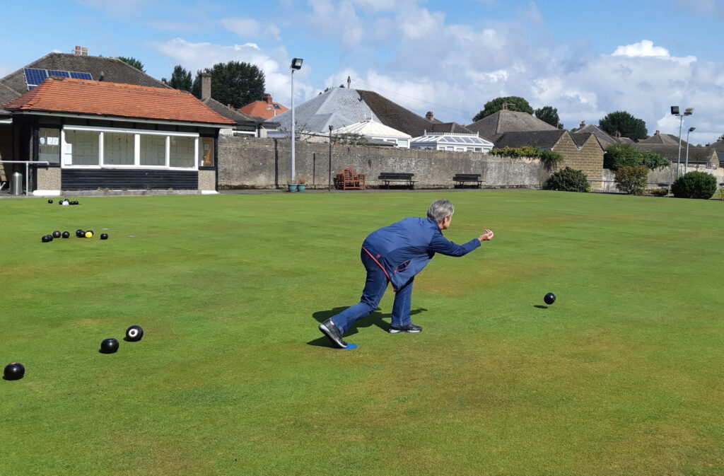 An action shot, bowling the wood