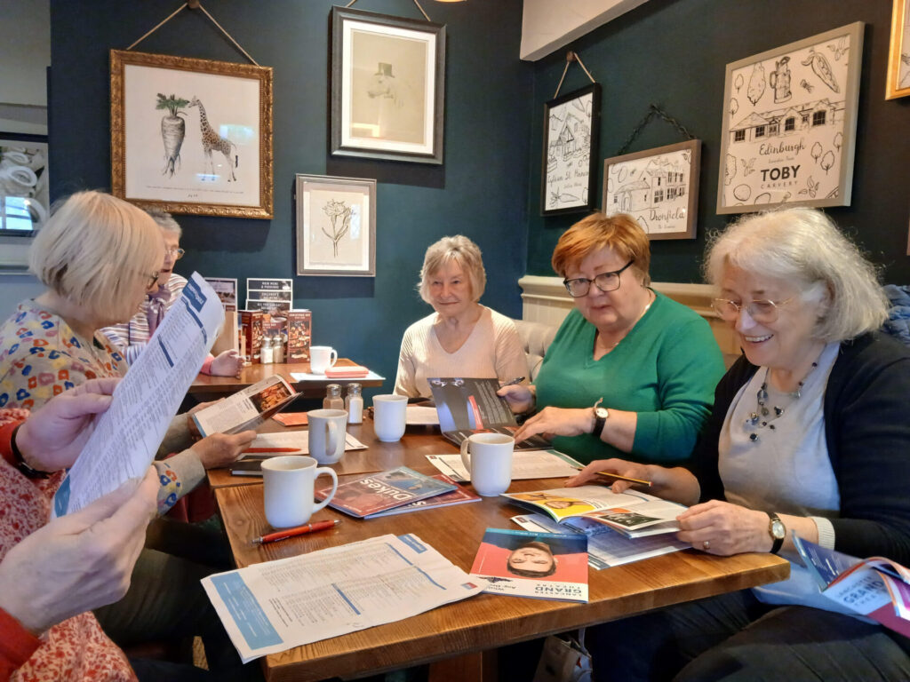 Members of Film and Theatre Friends discussing their next visits in the pub.