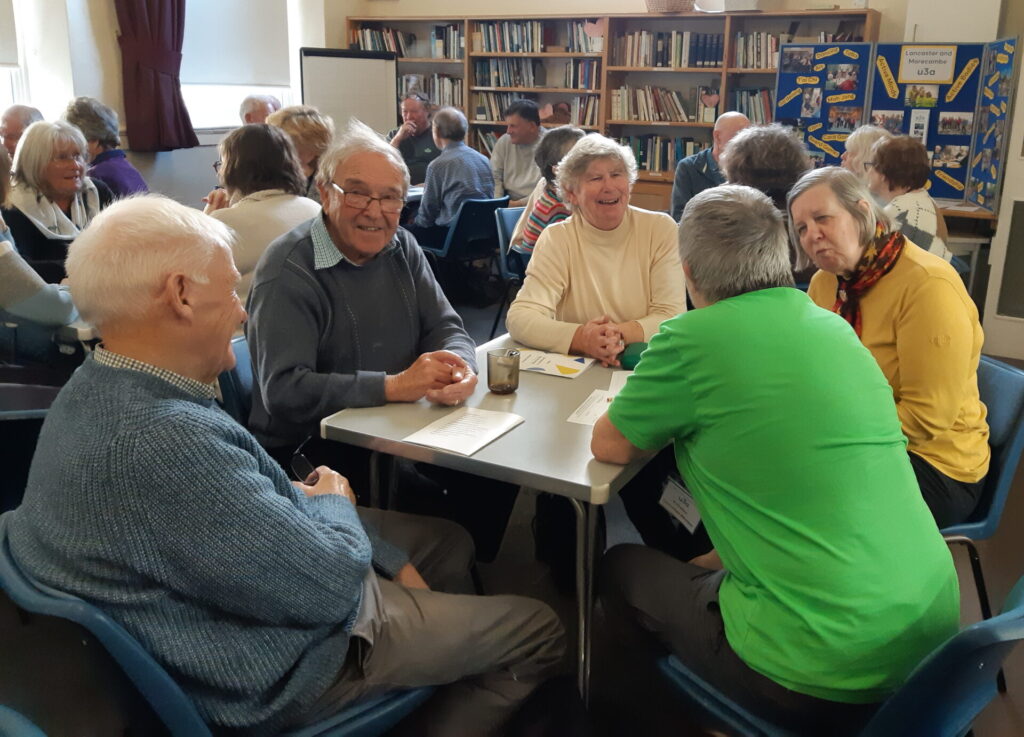 New members having a lively discussion at the meeting.