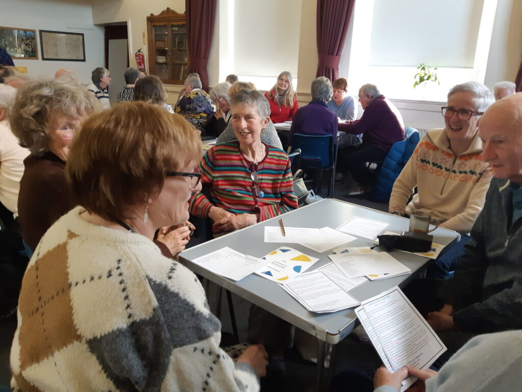 New members having a lively discussion at the meeting.