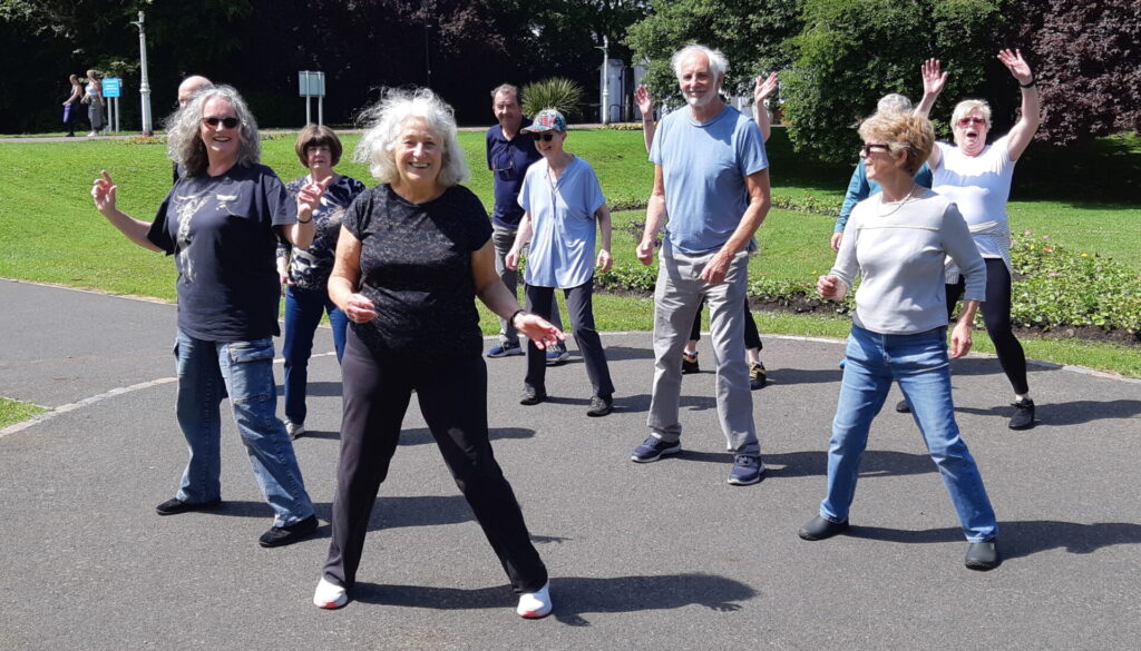 Happy smiling dancers in the park