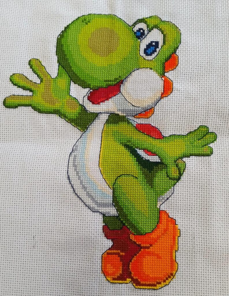 A cartoon figure in cross stitch