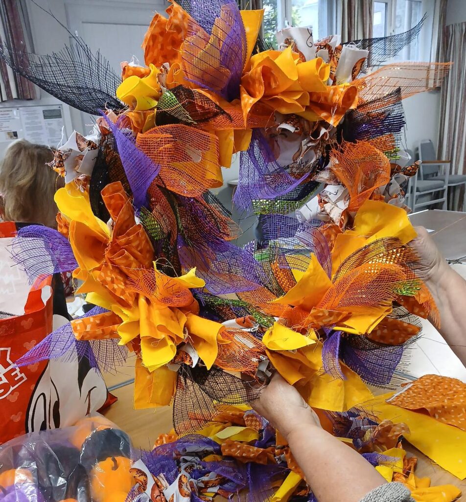 A colourful wreath made of different materials in autumn colours