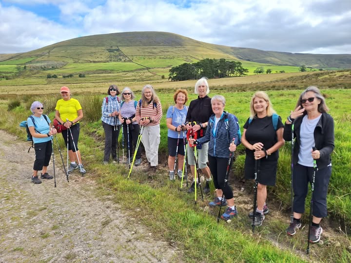 Having a rest with a hill in the background on the way to Bleasdale Tower.