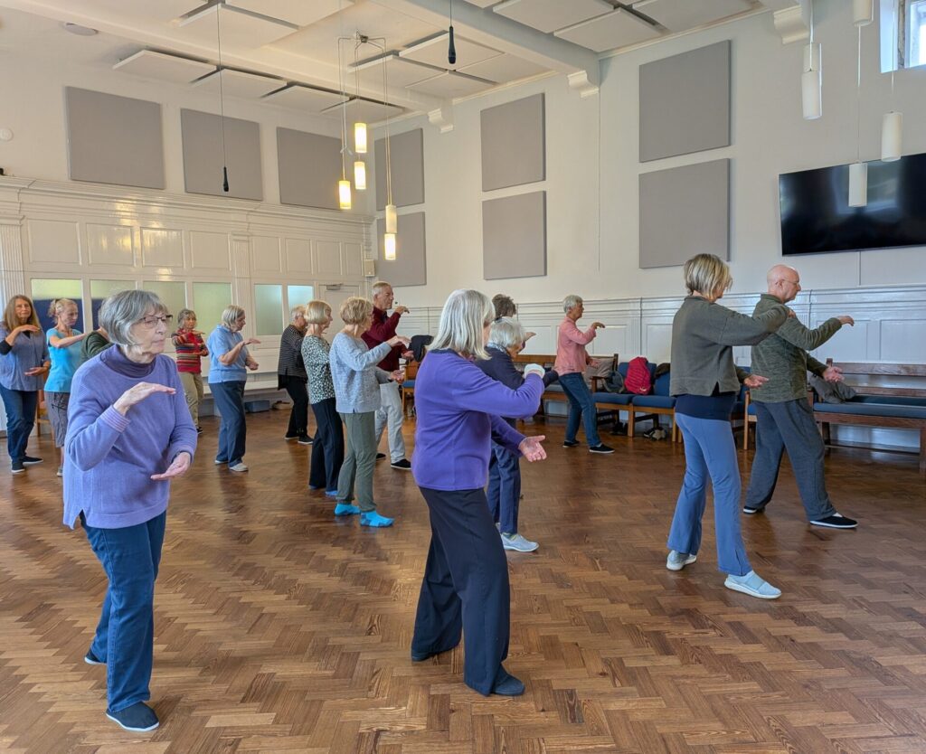 The group working on calm, Tai Chi moves.