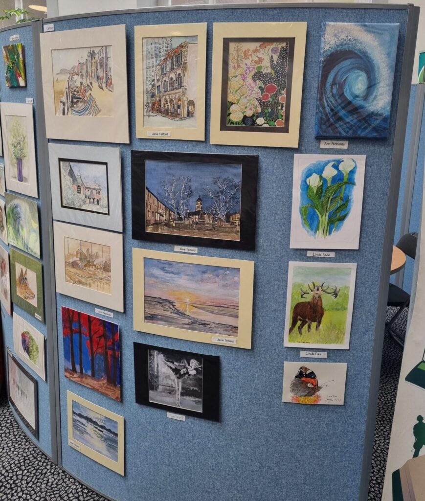 A selection of paintings by the Art4Fun group displayed in the library